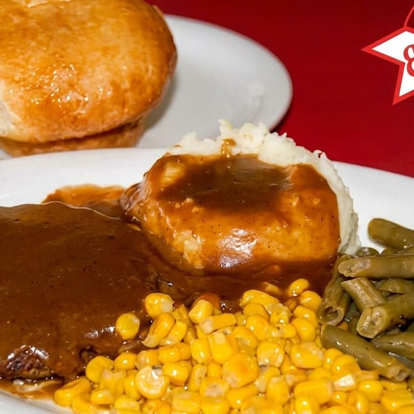 Ed Walker's Drive-In Salisbury steak with gravy, mashed potatoes, corn, green beans, and a biscuit.