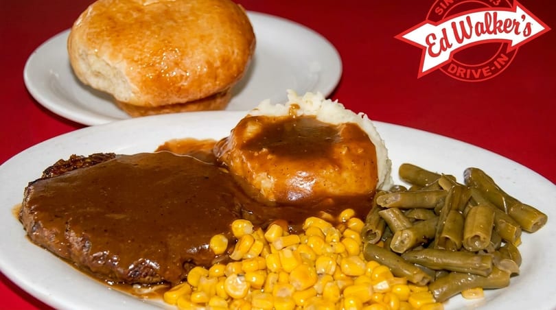 Ed Walker's Drive-In Salisbury steak with gravy, mashed potatoes, corn, green beans, and a biscuit.